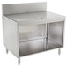 A stainless steel Advance Tabco drainboard cabinet with a shelf.