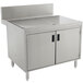 A stainless steel Advance Tabco drainboard cabinet with doors over a sink.
