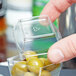 A person opening a clear plastic container of food with a finger.