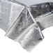 A silver metallic Creative Converting tablecloth on a table.