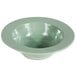 A green Elite Global Solutions melamine bowl with a white rim.