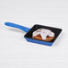 An Elite Global Solutions blue speckled faux cast iron skillet with a cinnamon roll inside.