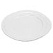 A close-up of a white Elite Global Solutions Della Terra melamine plate with a curved edge.