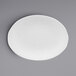A white oval platter with a rim on a gray surface.