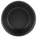 A close-up of a black round bowl with a textured surface.