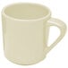 A close-up of a white coffee mug with a handle.