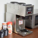 a coffee maker and coffee cups