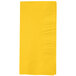 A yellow rectangular napkin with a square pattern.