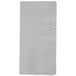 A close-up of a folded white Creative Converting dinner napkin.