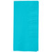 A close up of a blue paper napkin with a white border.