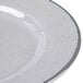 A close-up of an Elite Global Solutions Mojave gray crackle melamine plate with a curved line on the rim.