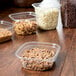 A group of Square Recycled PET Deli containers with different types of food.