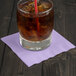 A glass of ice tea with a straw on a Luscious Lavender purple napkin.