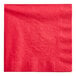 A close-up of a red napkin with a white background.