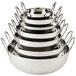 A stack of silver stainless steel balti dishes with handles.