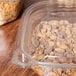 A Square Recycled PET deli container lid on a plastic container with food in it.