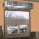 A window with a car parked in front of a Curtron drive-thru air curtain