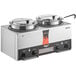 A silver Vollrath Cayenne Twin Well rethermalizer on a countertop with two black lids.