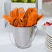 A bucket of Sunkissed Orange Creative Converting plastic forks.