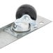 A metal plate with a black wheel.