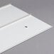 A white plastic sheet with a hole in it.