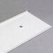 A white plastic sheet with a hole in it.