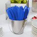 A bucket of Creative Converting cobalt blue plastic knives.