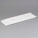 A white rectangular plastic shield with two holes.