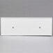 A white rectangular object with two holes on top.