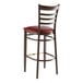 A Lancaster Table & Seating metal bar stool with a burgundy vinyl seat and dark walnut finish.