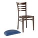 A brown Lancaster Table & Seating Spartan Series metal ladder back restaurant chair with navy vinyl seat.