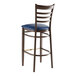 A metal ladder back bar stool with a dark walnut wood grain finish and a navy vinyl seat.