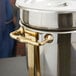 A gold metal side handle for a Vollrath soup chafer.