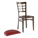 A Lancaster Table & Seating brown metal chair with a dark red vinyl seat.