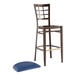 A Lancaster Table & Seating metal bar stool with a navy vinyl seat.