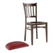 A Lancaster Table & Seating brown wooden chair with a dark red cushion.