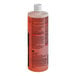 A close up of a 3M Scotch-Brite Liquid Griddle Quick Clean bottle with red liquid inside.