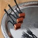 A silver tray with WNA Comet black tasting forks.