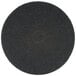 A black circular 3M floor pad with a circle in the middle.