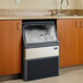 A Follett Maestro Plus undercounter ice machine in a kitchen making chewblet ice.