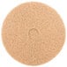 A 3M tan burnishing floor pad, a circular tan pad with a circle in the middle.