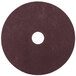 A brown circular 3M Scotch-Brite surface preparation pad with a hole in the middle.
