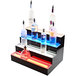 A Beverage-Air two-tiered liquor display shelf holding glass liquor bottles with LED lighting.