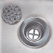 A close-up of the drain on an Advance Tabco stainless steel hand sink.