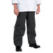 A person wearing Chef Revival black and white striped chef pants.