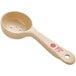 A Carlisle beige polycarbonate measuring spoon with red perforated handle.