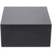 A black rectangular cube riser on a white surface.
