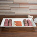 An American Metalcraft Antique White Melamine platter with sliced meat and cheese on it.