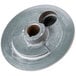A close-up of an Avantco turning plate, a round metal disc with holes.