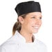 A woman wearing a black Chef Revival baker's skull cap with a mesh top.